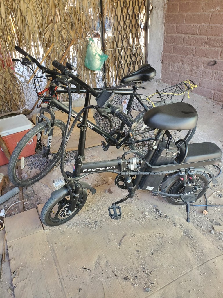 An ebike and a normal bicycle next to eachother